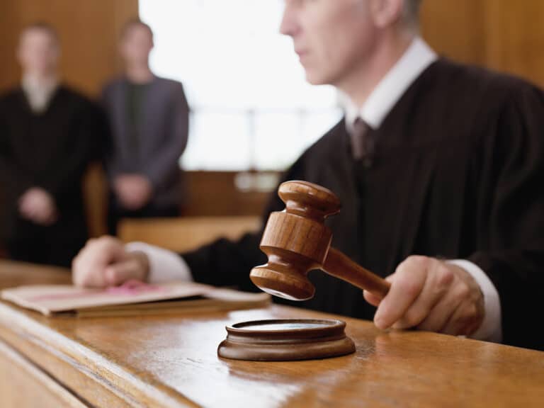 Judge holding gavel in courtroom