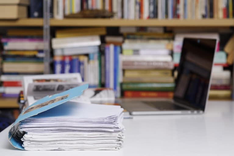 Stack of files and computer at the library