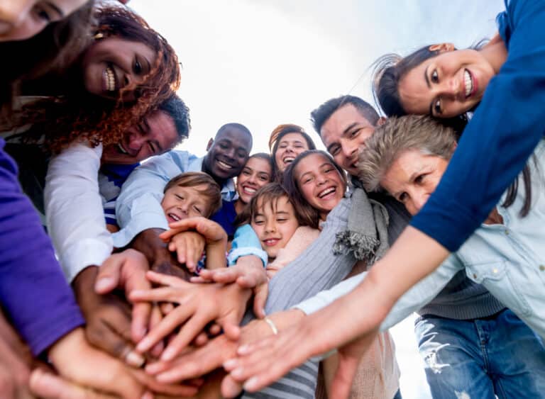 Team with hands together and looking very happy - teamwork concepts